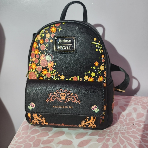 Loungefly Handbags - Loungefly coco remember me back pack with upside down logo